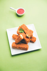 Kurkuri paneer fingers or pakora/pakoda snacks also known as Crispy Cottage Cheese Bars, served with tomato ketchup as a starter. selective focus