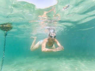 woman snorkeling in clear tropical waters - active holiday