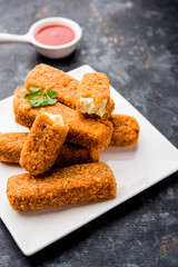 Kurkuri paneer fingers or pakora/pakoda snacks also known as Crispy Cottage Cheese Bars, served with tomato ketchup as a starter. selective focus