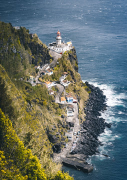 Dramatic view down to lighthouse on Ponta do Arnel, Nordeste, Sao Miguel Island, Azores, Portugal