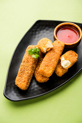 Kurkuri paneer fingers or pakora/pakoda snacks also known as Crispy Cottage Cheese Bars, served with tomato ketchup as a starter. selective focus