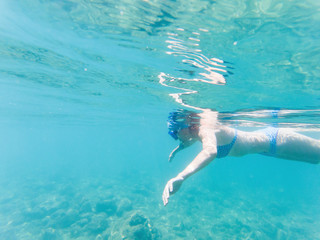 woman snorkeling in clear tropical waters - active holiday