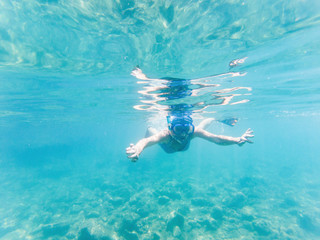 woman snorkeling in clear tropical waters - active holiday