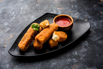 Kurkuri paneer fingers or pakora/pakoda snacks also known as Crispy Cottage Cheese Bars, served with tomato ketchup as a starter. selective focus