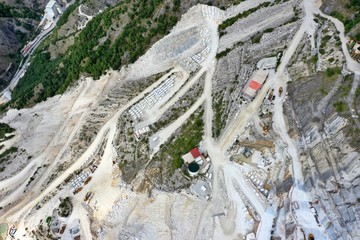 Aerial view of mountain of stone and marble quarries in the regional natural park of the Apuan Alps located in the Apennines in Tuscany, Massa Carrara Italy. Open pit mine