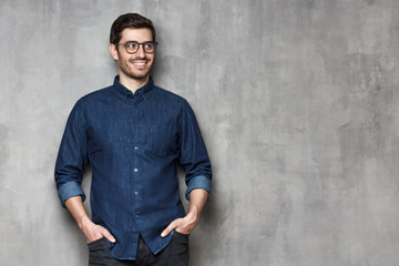 Young male looking aside with interest, isolated, copyspace on right