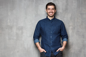 Obraz premium Portrait of relaxed man isolated on gray backgrund