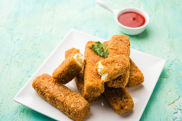 Kurkuri paneer fingers or pakora/pakoda snacks also known as Crispy Cottage Cheese Bars, served with tomato ketchup as a starter. selective focus