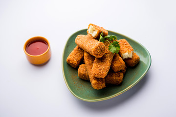 Kurkuri paneer fingers or pakora/pakoda snacks also known as Crispy Cottage Cheese Bars, served with tomato ketchup as a starter. selective focus