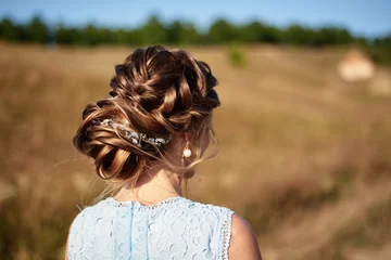 Selbstklebende Fototapeten Friseursalon Beautiful bride wedding hairstyle with jewelry, back view. Girl with curly hair styling outdoors. Hairdo for long hair with elegant accessories  © mirage_studio
