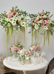 Luxury floral arrangement of pink and white flowers in glass vases on wood table, copy space. Wedding decorations, holiday concept