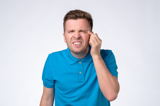 Man With Narrow Eyes Squinting Trying To See Small Text