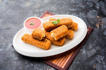 Kurkuri paneer fingers or pakora/pakoda snacks also known as Crispy Cottage Cheese Bars, served with tomato ketchup as a starter. selective focus