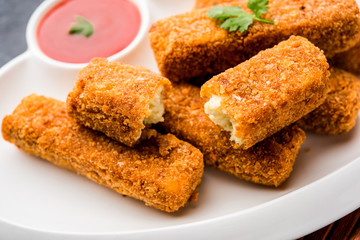 Kurkuri paneer fingers or pakora/pakoda snacks also known as Crispy Cottage Cheese Bars, served with tomato ketchup as a starter. selective focus