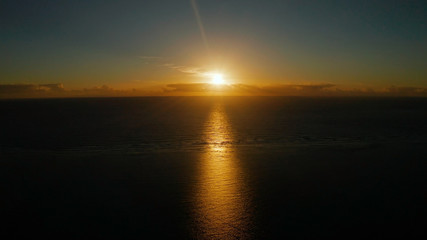 Sunrise above the sea surface with waves, aerial view. Sunrise over ocean. Philippines