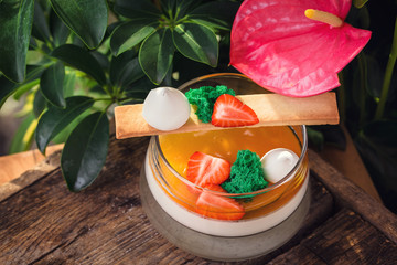 Panakota dessert with strawberry pieces on a wooden board