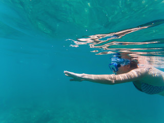woman snorkeling in clear tropical waters - active holiday