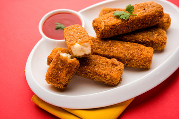 Kurkuri paneer fingers or pakora/pakoda snacks also known as Crispy Cottage Cheese Bars, served with tomato ketchup as a starter. selective focus