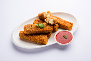 Kurkuri paneer fingers or pakora/pakoda snacks also known as Crispy Cottage Cheese Bars, served with tomato ketchup as a starter. selective focus