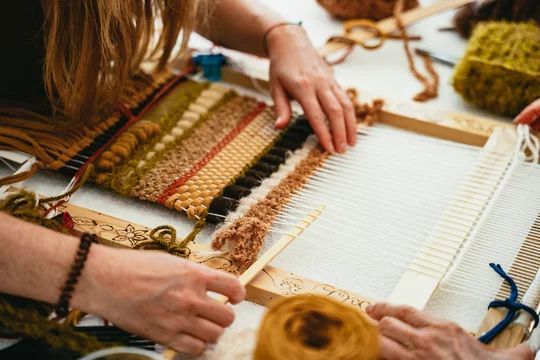 Woman trying her hand at weaving a tapestry Stock Photo | Adobe Stock