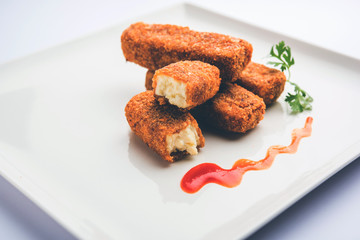 Kurkuri paneer fingers or pakora/pakoda snacks also known as Crispy Cottage Cheese Bars, served with tomato ketchup as a starter. selective focus