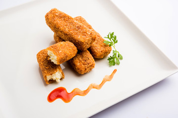 Kurkuri paneer fingers or pakora/pakoda snacks also known as Crispy Cottage Cheese Bars, served with tomato ketchup as a starter. selective focus