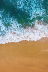 Fototapeta na wymiar Aerial view of Blue ocean wave on sand beach.