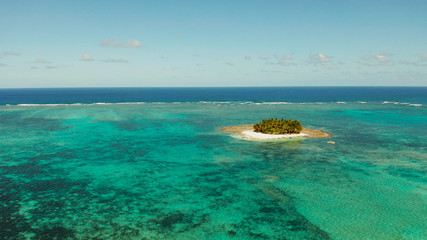 Seascape with beautiful beach and tropical island palm trees by coral reef from above. Guyam island, Philippines, Siargao. Summer and travel vacation concept