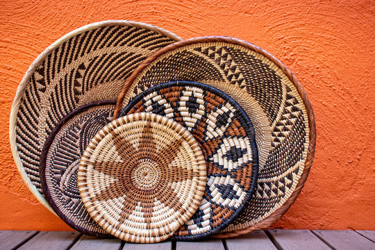 African grass baskets on an orange background