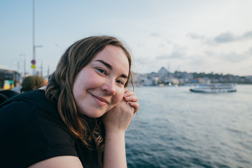 Tourist girl on the background of the sea and the city view