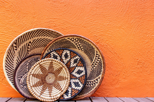 African grass baskets on an orange background