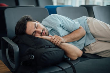 The guy at the airport is waiting for departure, asleep