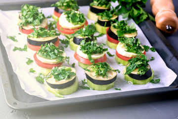 Piles of Raw Eggplants Zucchini Tomatoes Decorated with Chopped Parsley on Baking Tray Ready to Grill or Roast Vegetarian Snack Vegan Diet Healthy Dish