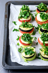 Piles of Raw Eggplants Zucchini Tomatoes Decorated with Chopped Parsley on Baking Tray Ready to Grill or Roast Vegetarian Snack Vegan Diet Healthy Dish