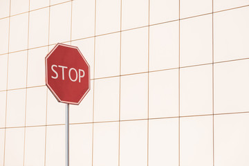 Stop sign in geometric pattern background. Street photo of a road sign with copy space