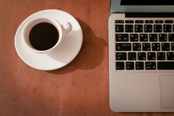 Laptop keyboard with coffee cup