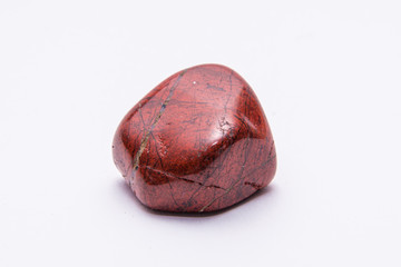Breckzien jasper gem shining in powerful tones of deep red isolated