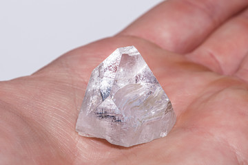 Rough diamond formed by volcanic heat and pressure inside earth in hand