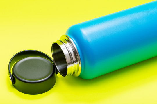 Blue Wide Mouth Insulated Stainless Steel Bottle with Wide Flat Cap isolated on bright yellow background. BPA-Free. Double Wall Vacuum Insulation.