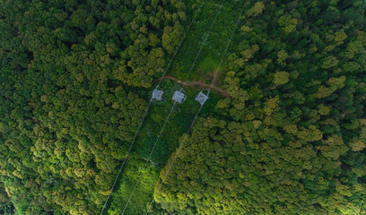 Aerial view. High voltage metal post. High-voltage towers in the forest.