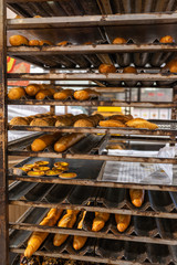 Freshly baked buns and pastry from oven at confectionery factory