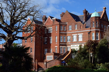 Fototapeta na wymiar Big typical English building made of brown brick at Eastbourne city