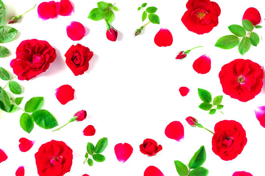 Red roses with leaves and buds on a white background. Background for holiday, birthday,  Mother's Day, Valentine's day, Women's Day. Top view, flat lay composition. Copy space for text or design.