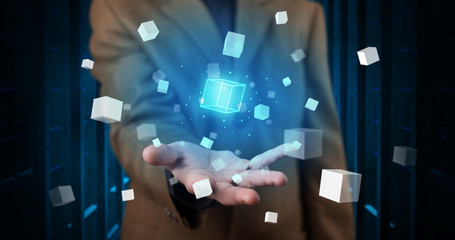 Person holding hologram projection displaying white cubes in server room