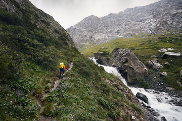 Climber with backpack in the mountains