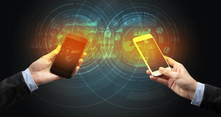 Close up of two smartphones syncing business data