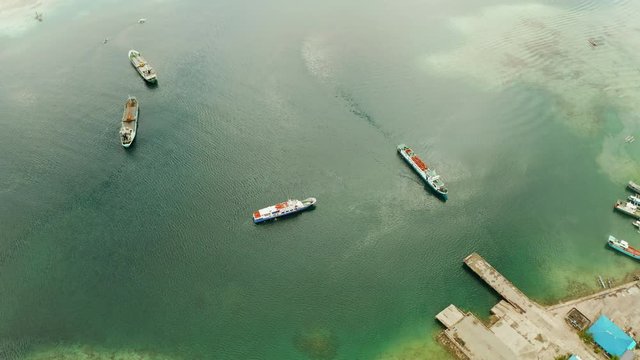 Freight ships and ferries in the bay, top view. Dapa Ferry Terminal. Siargao, Philippines.