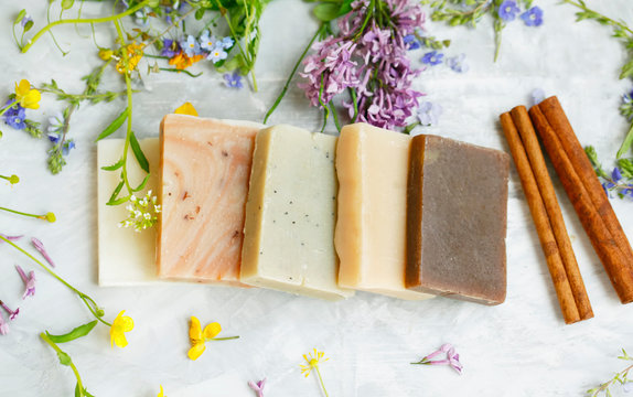 Natural handmade soap bars with organic medicinal plants and flowers.Homemade beauty products with natural essential oils from plants and flowers, top view closeup photo