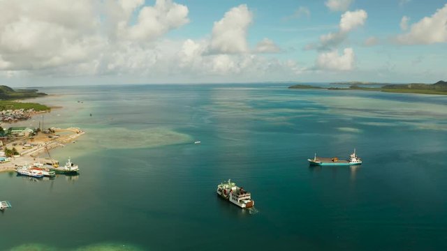 Passenger port with ferries and cargo ships on the island of Siargao,aerial view. Dapa Ferry Terminal. Siargao, Philippines.