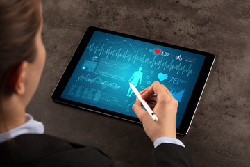 Business woman making healthy analysis on tablet
